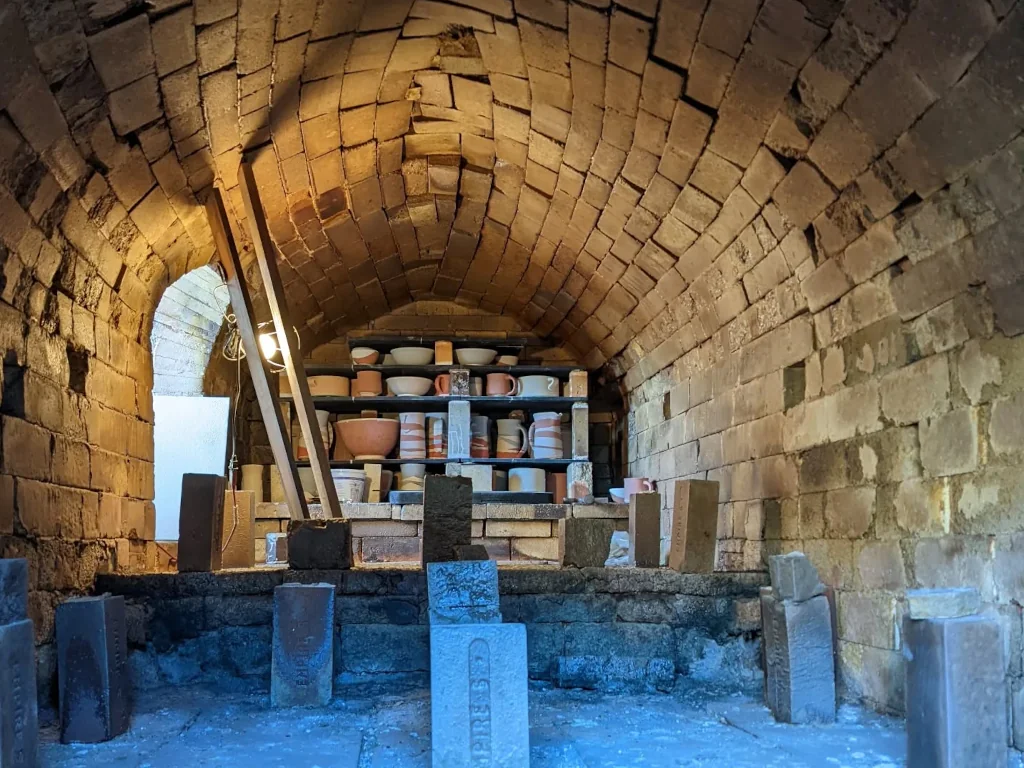 Stacked kiln shelves loaded with pottery