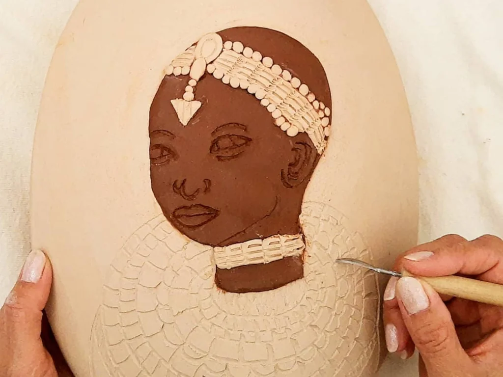 Carving and painting imagery on a vase